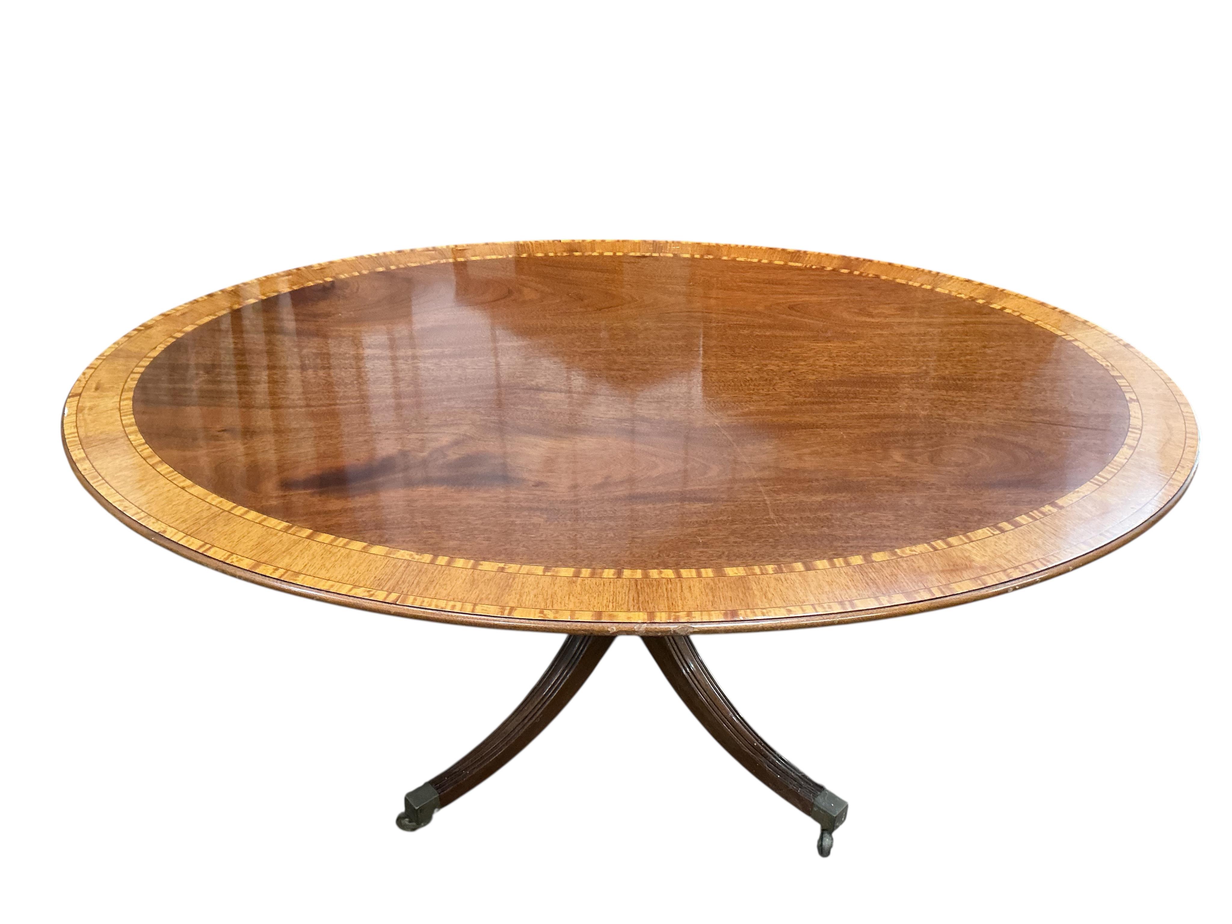 A reproduction William Tillman George III style oval banded mahogany dining table (lacks bolts), width 168cm, depth 120cm, height 72cm